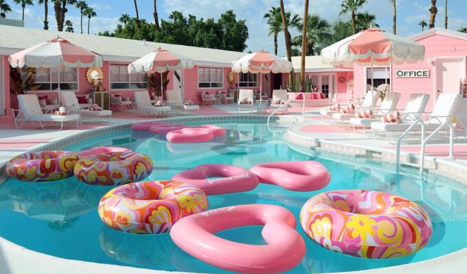 Trixie Motel swimming pool with pink floats, Barbie hotel style, in Palm Springs, California, USA.