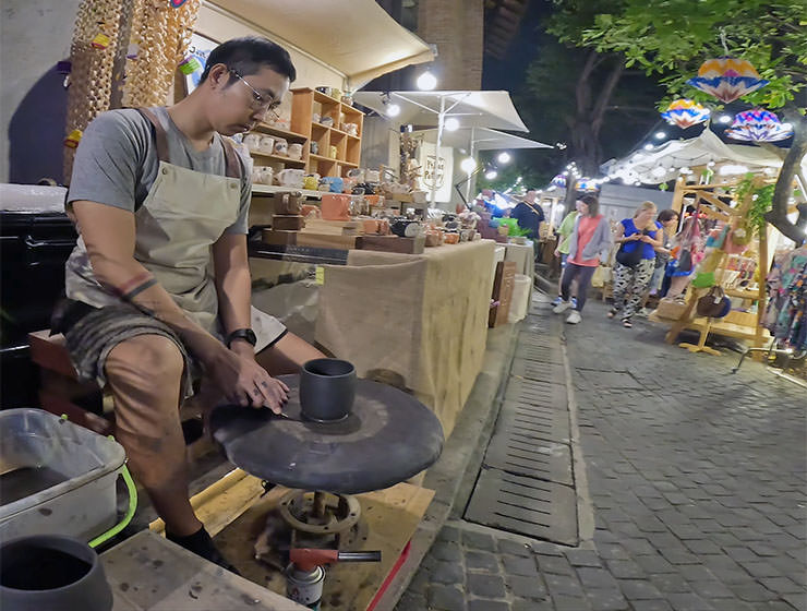 An artist spinning a clay on a wheel at the White Market, Japanese-Lanna night street market in Chiang Mai, Thailand; photo by Ivan Kralj.