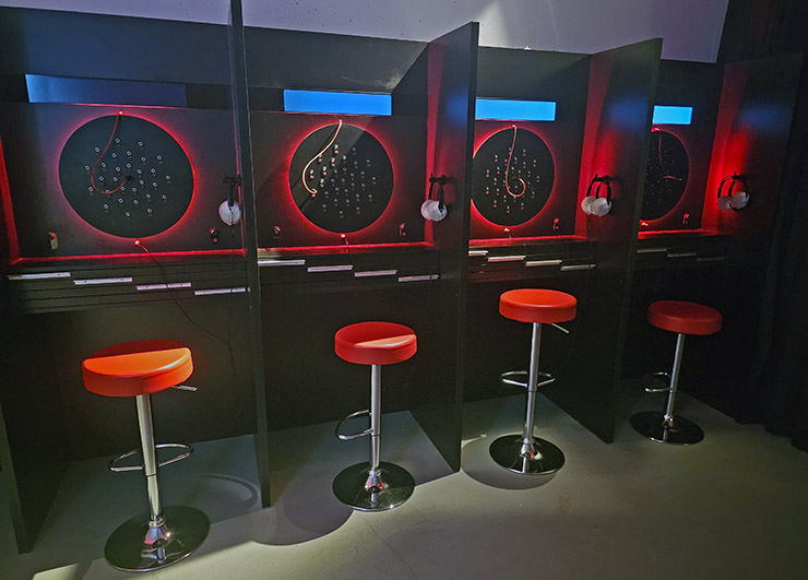 Red bar stools in front of telephone switchboards in Secret Rooms of Hotel Jama, Postojna, Slovenia, which enable listening into conversations of monitored persons in the communist times; photo by Ivan Kralj.