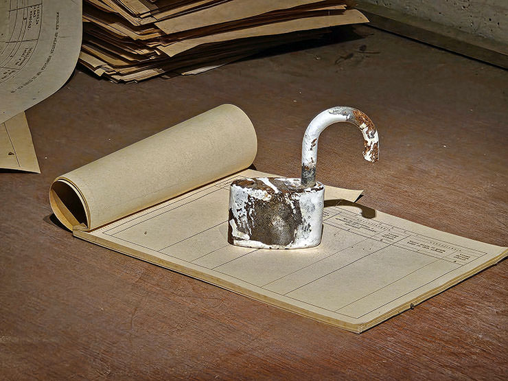 Heavy lock on a block of paper forms, in the spy center inside Slovenian Hotel Jama, Postojna, a secret space for monitoring suspects during the communist regime; photo by Ivan Kralj.