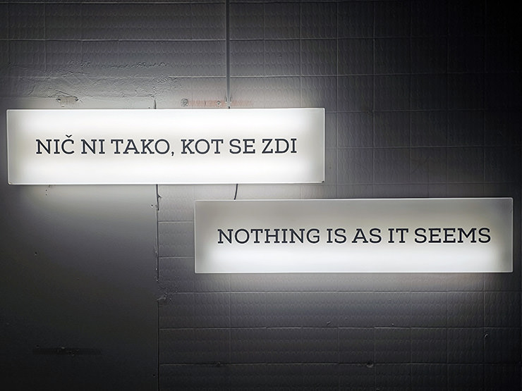 Neon signs in Slovenian and English saying "Nothing is as it seems", displayed in one of the Secret Rooms at Hotel Jama, Postojna, Slovenia; photo by Ivan Kralj.