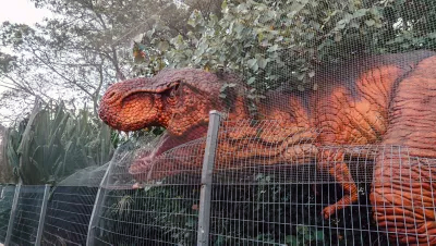 T-Rex attacking over the fence at Changi Jurassic Mile, an outdoor dino trail at Singapore Changi Airport; copyright Changi Airport.