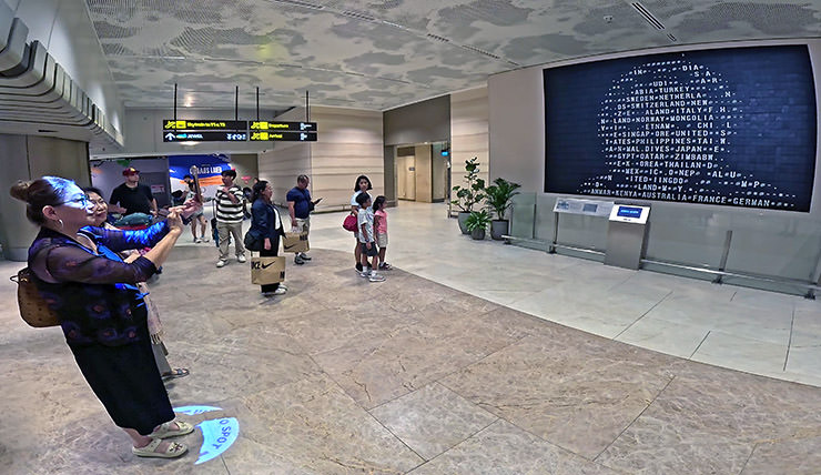 Flap Pix, a mechanical split-flap display board of flight information repurposed into artwork displaying passengers' portraits at Changi Airport Terminal 2, Singapore; photo by Ivan Kralj.