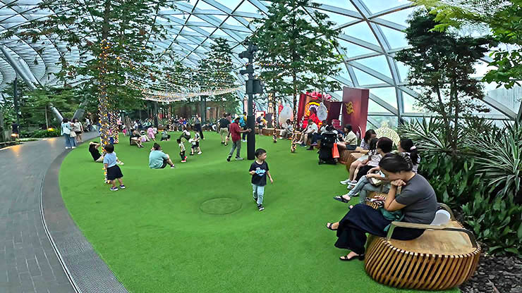 A place called Foggy Bowls, with children and parents waiting for the green pits to be filled with mist, at Canopy Park, Jewel Changi Airport, Singapore; photo by Ivan Kralj.