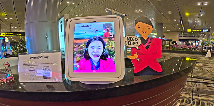 Iris, Changi Airport ambassador helping out a passenger at virtual information desk via a screen, Singapore Airport, Terminal 3; photo by Ivan Kralj.