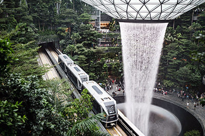 Skytrain passing by the Rain Vortex in Jewel Changi Airport, Singapore; photo by Nathaniel Yeo, Unsplash.